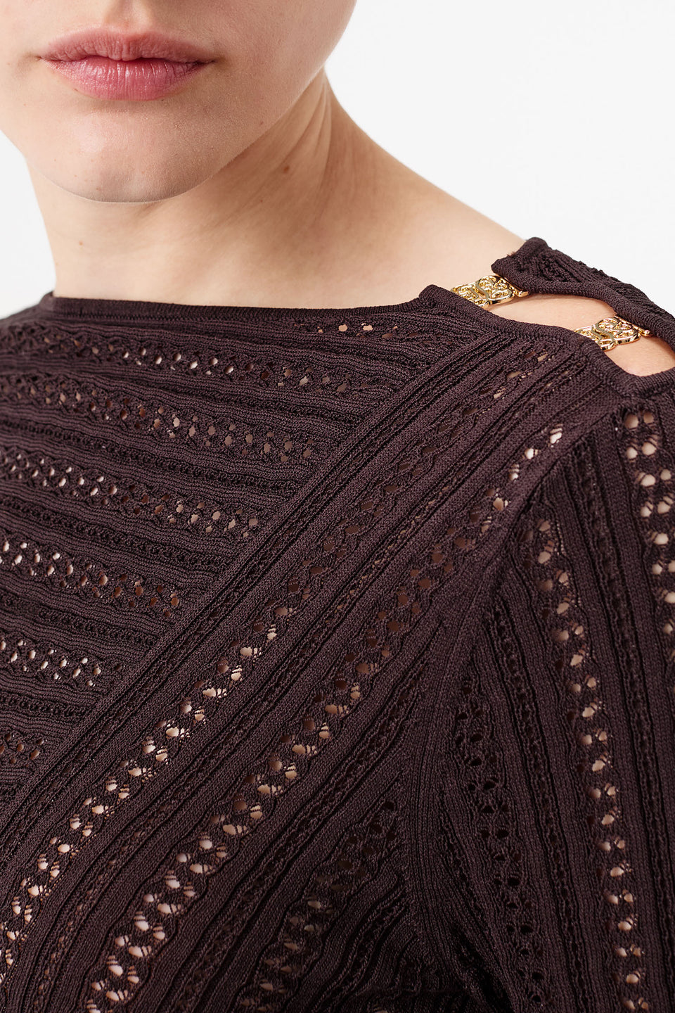 Knit top with asymmetrical cutouts