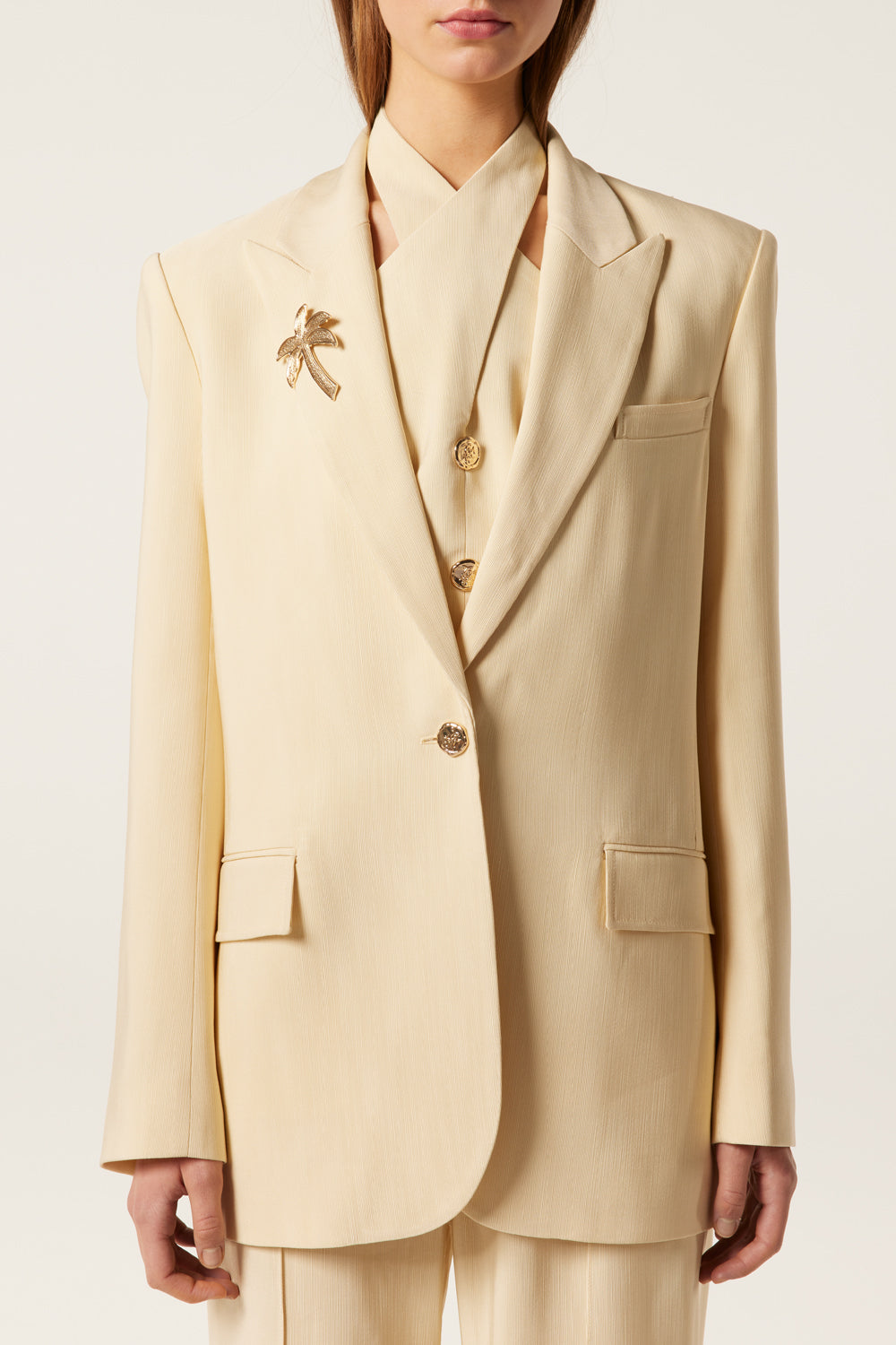 Tailored blazer with palm tree brooch