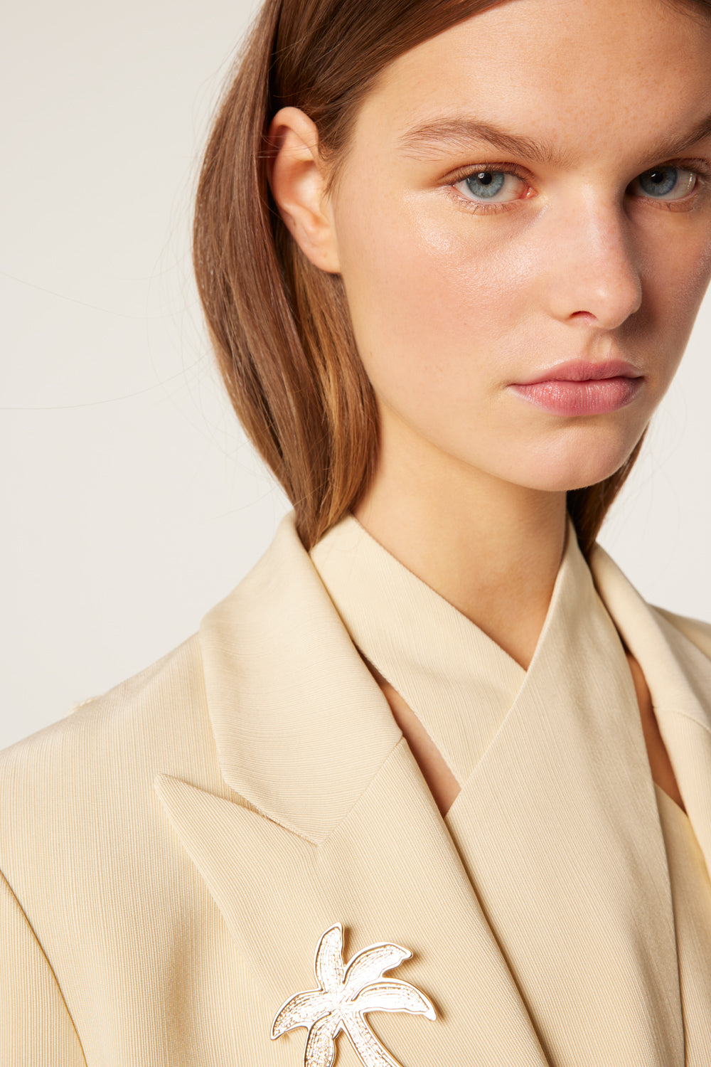 Tailored jacket with palm brooch