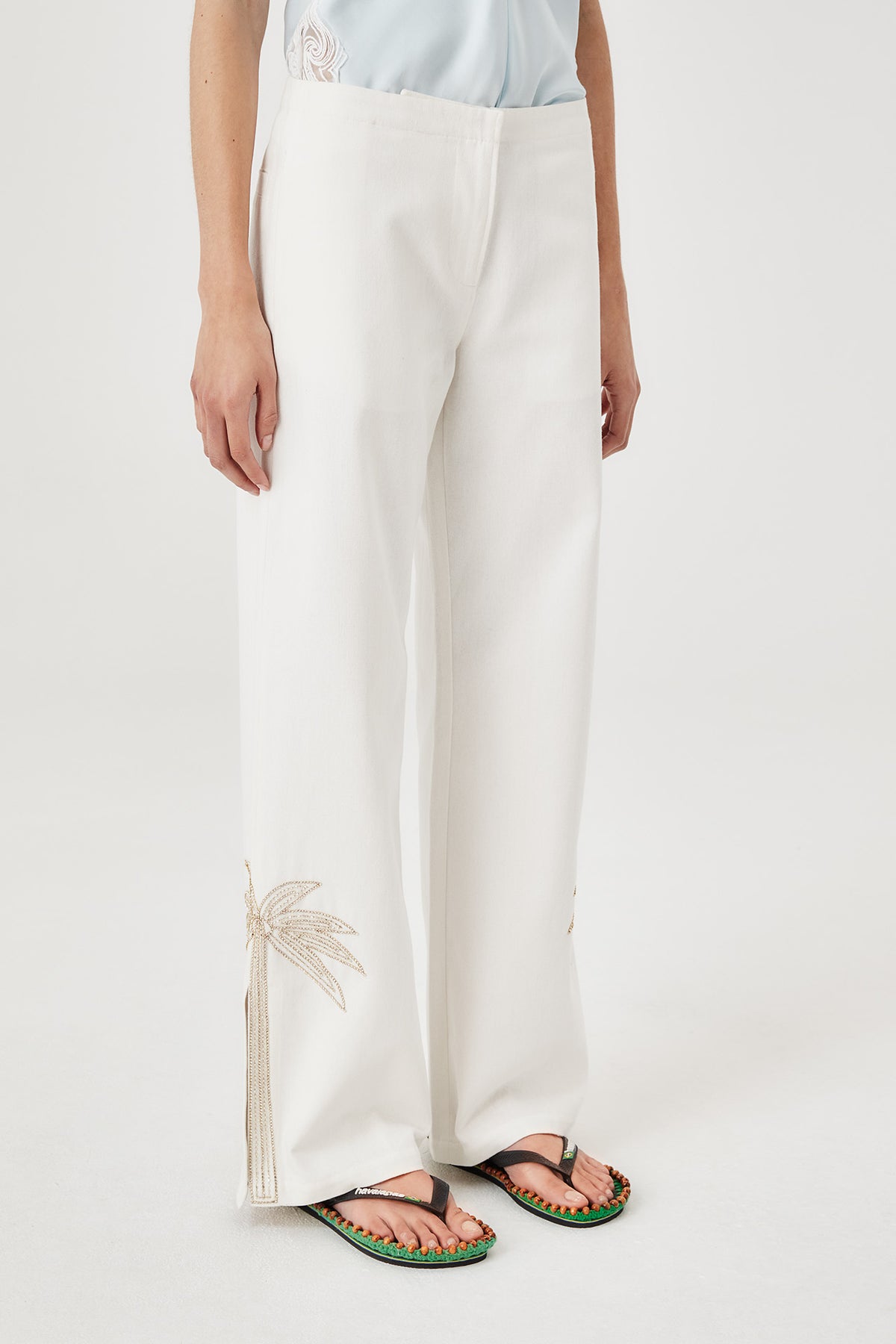 Pants with embroidered rhinestone palm tree