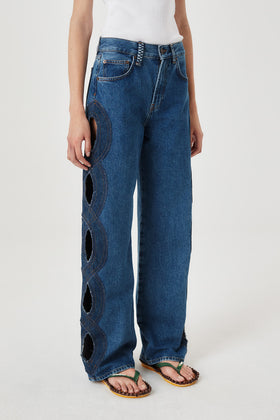 Denim jeans with braided opening
