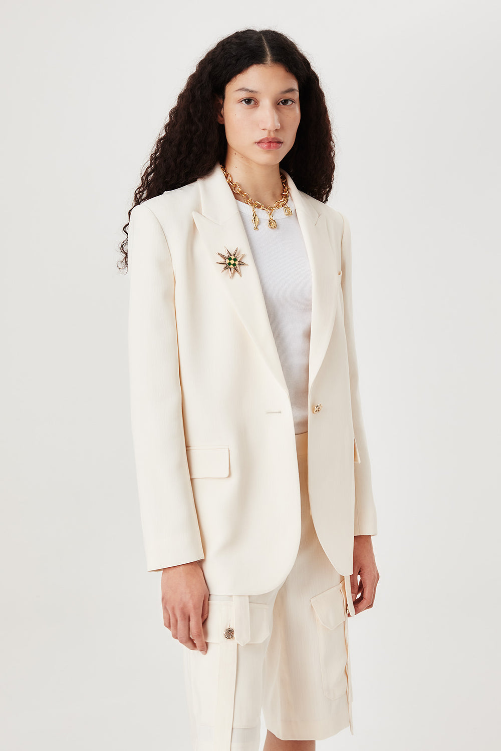 Tailored jacket with palm brooch