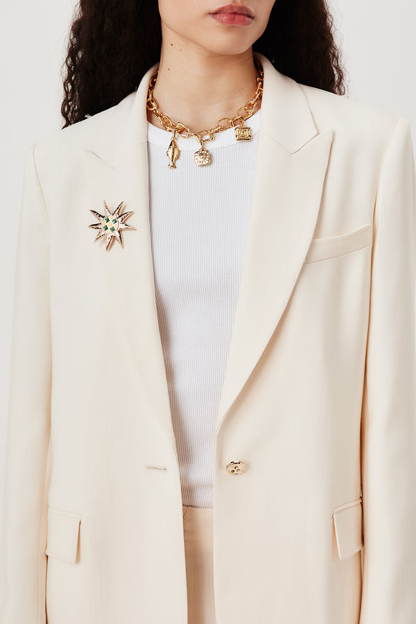 Tailored jacket with palm brooch