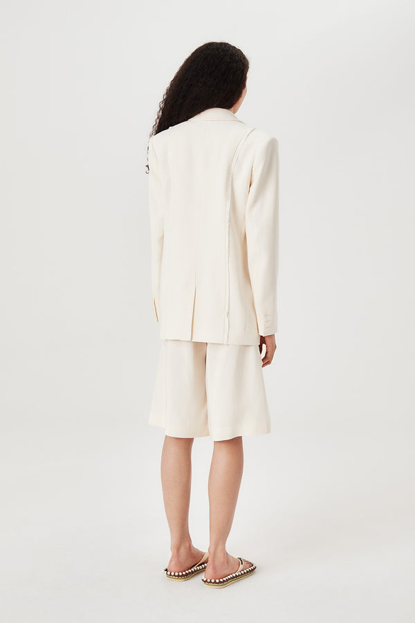 Tailored jacket with palm brooch