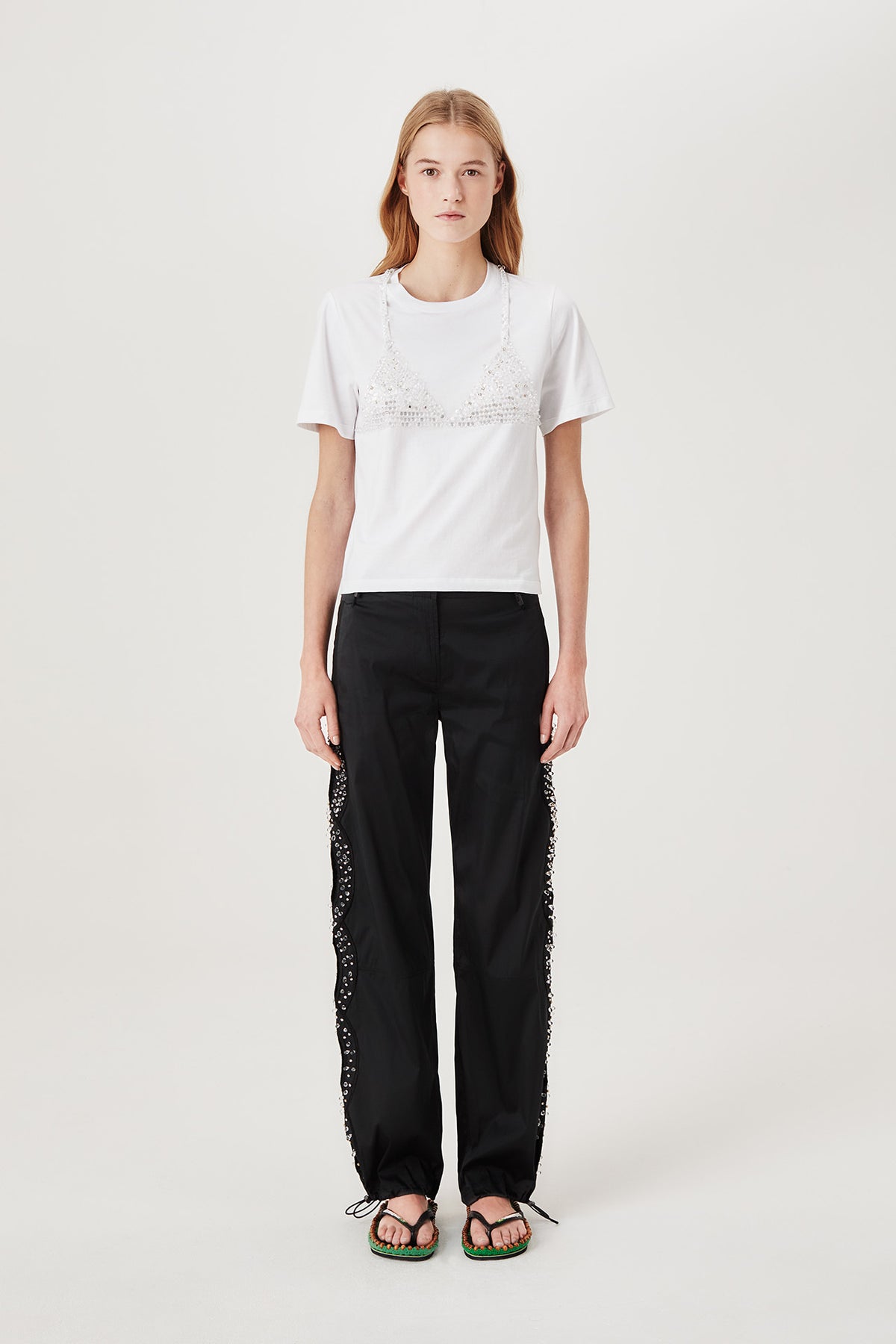 Trousers with rhinestone-embroidered braids