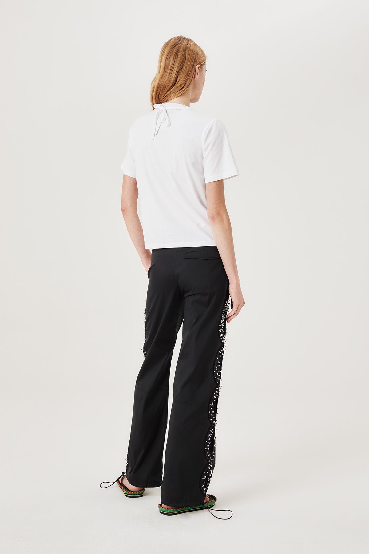 Trousers with rhinestone-embroidered braids