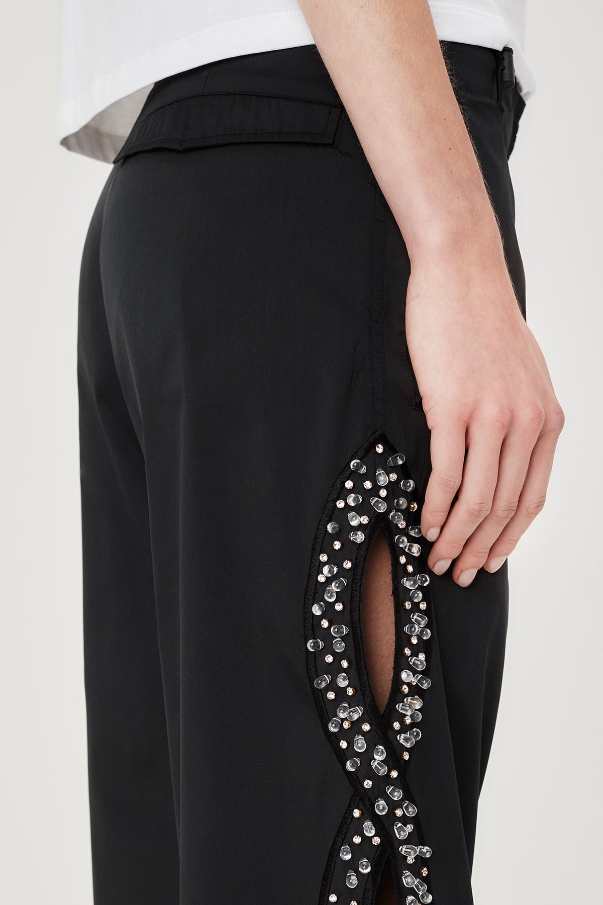 Trousers with rhinestone-embroidered braids