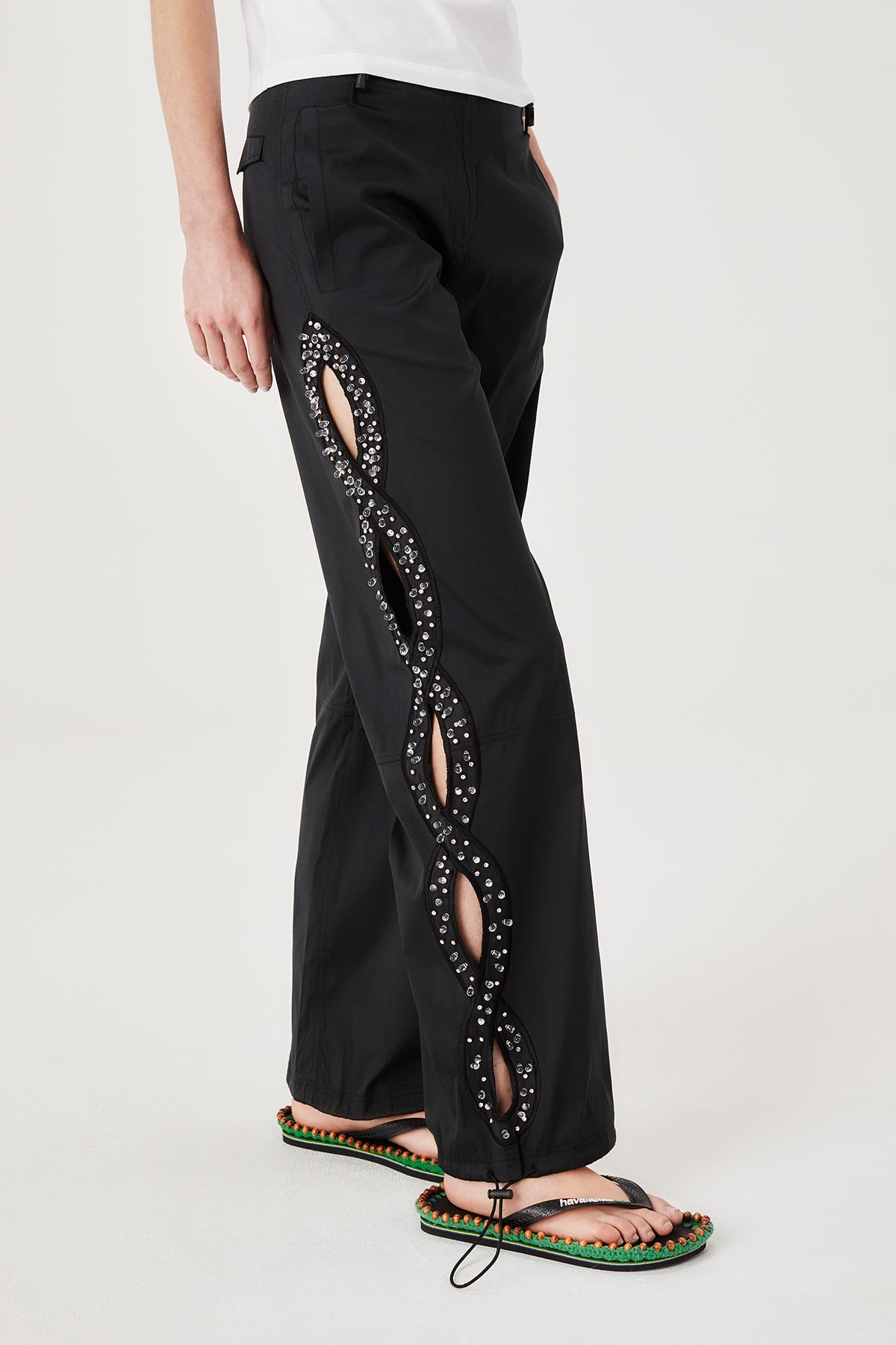 Trousers with rhinestone-embroidered braids