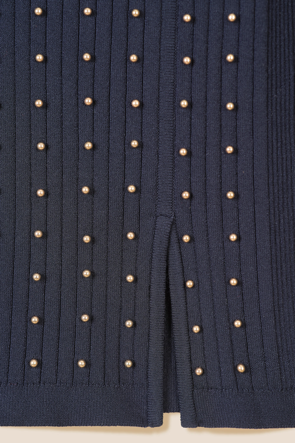 Sweater decorated with golden beads