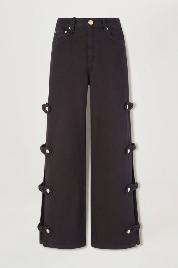 Denim noir ouvert aux côtés avec pattes tressées