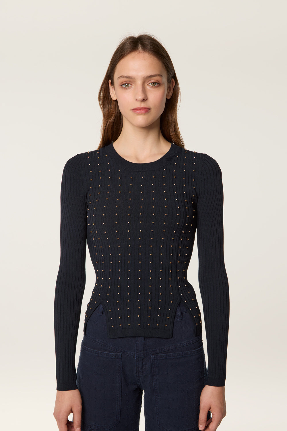 Sweater decorated with golden beads