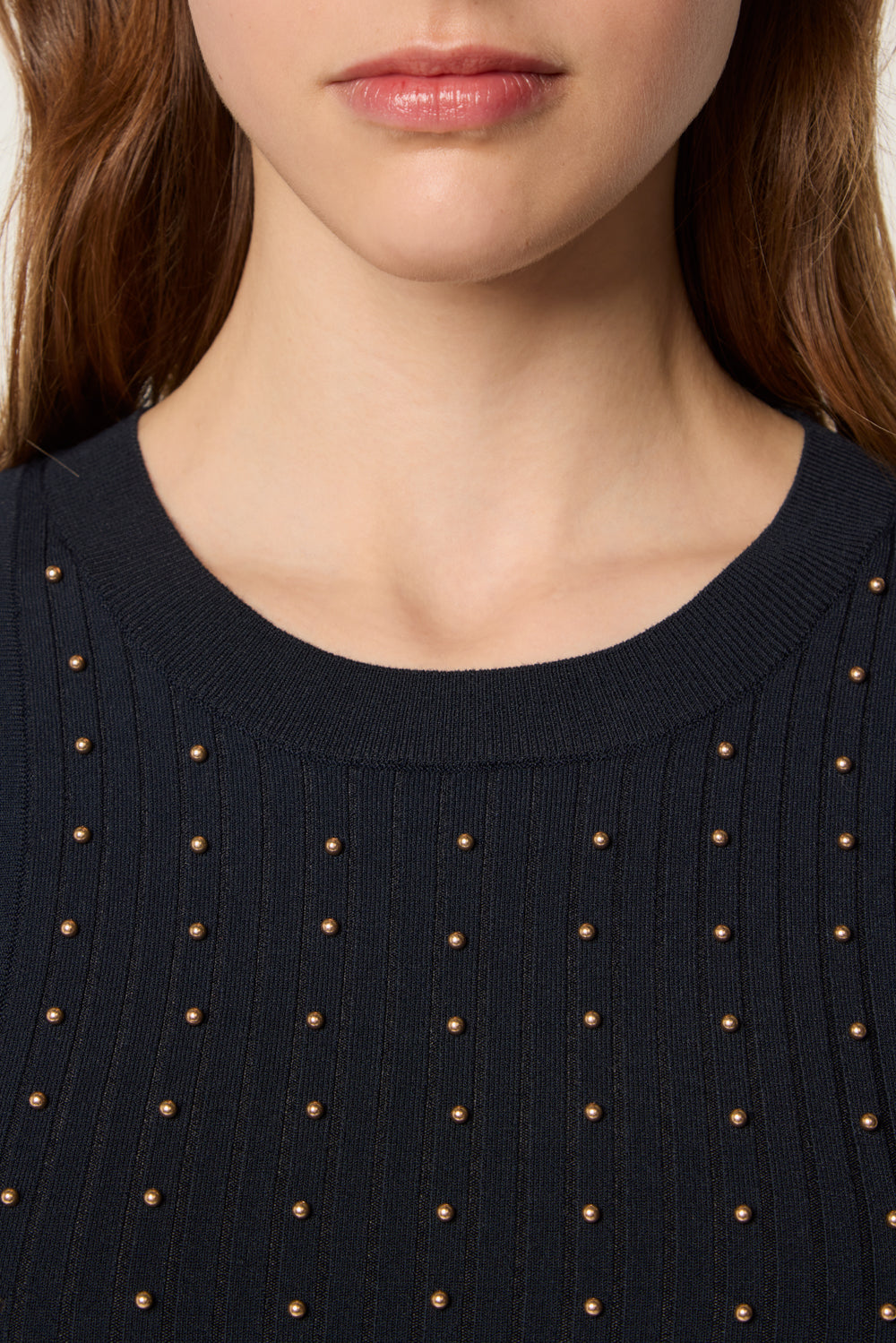 Sweater decorated with golden beads