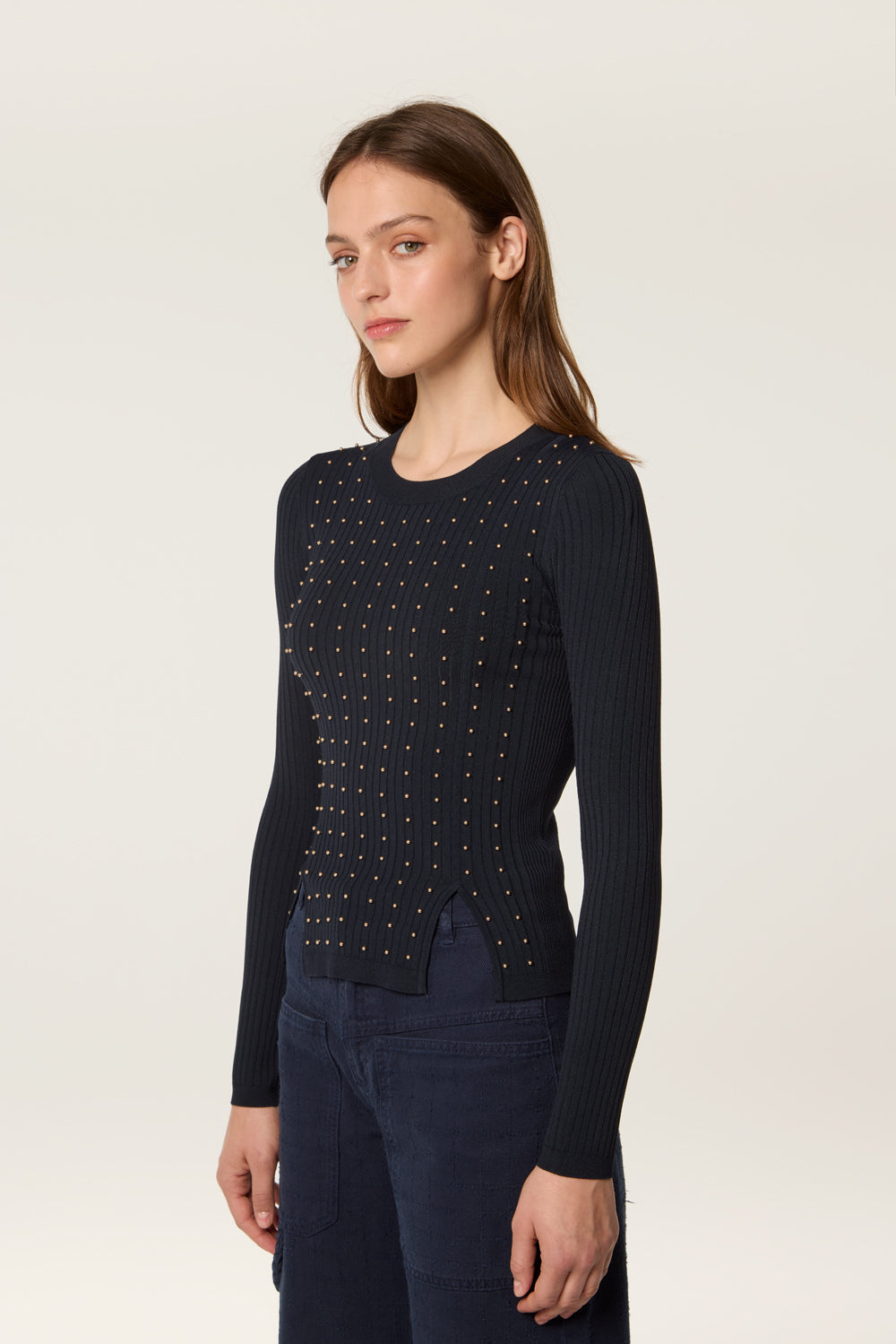 Sweater decorated with golden beads