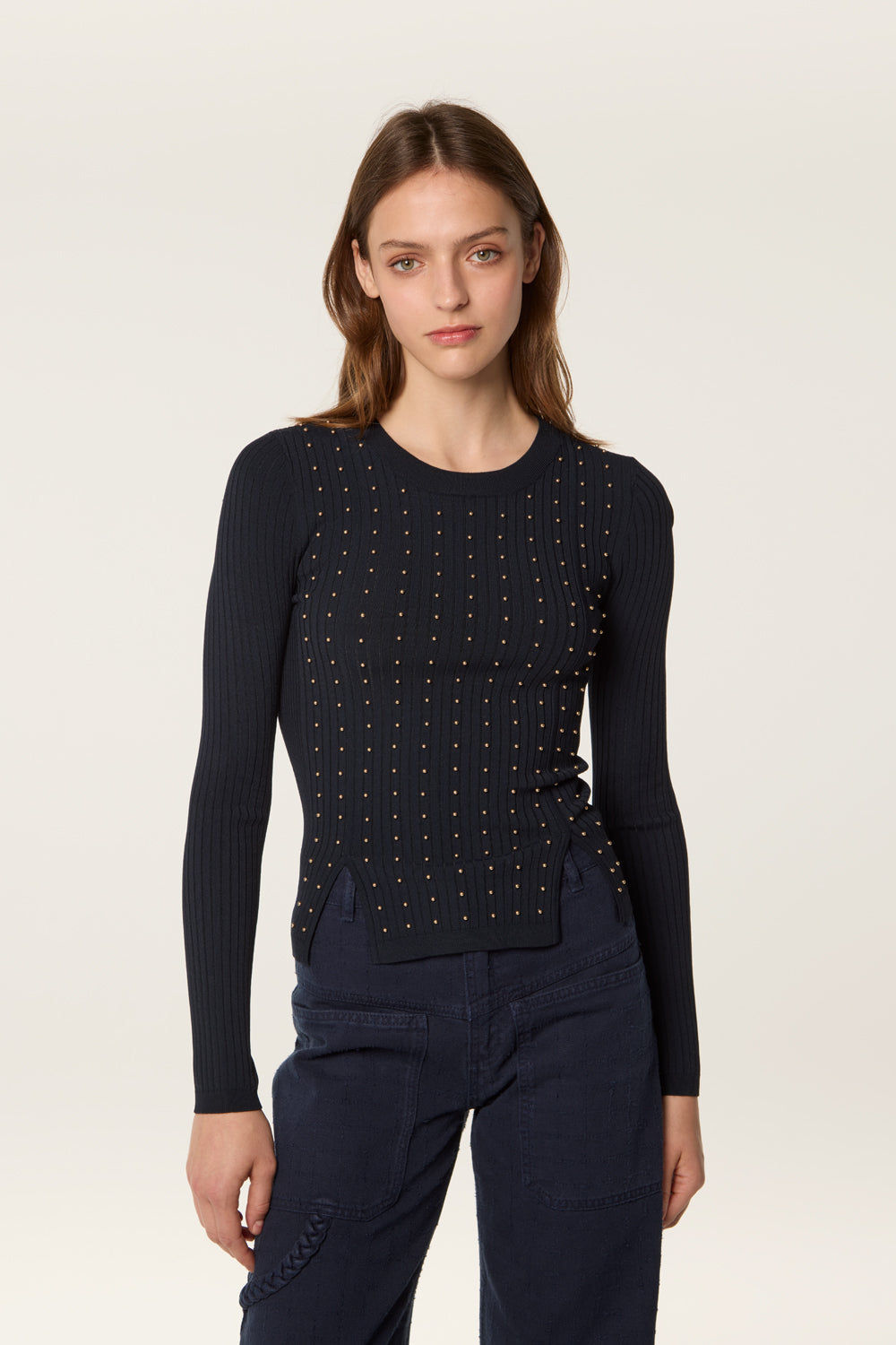 Sweater decorated with golden beads