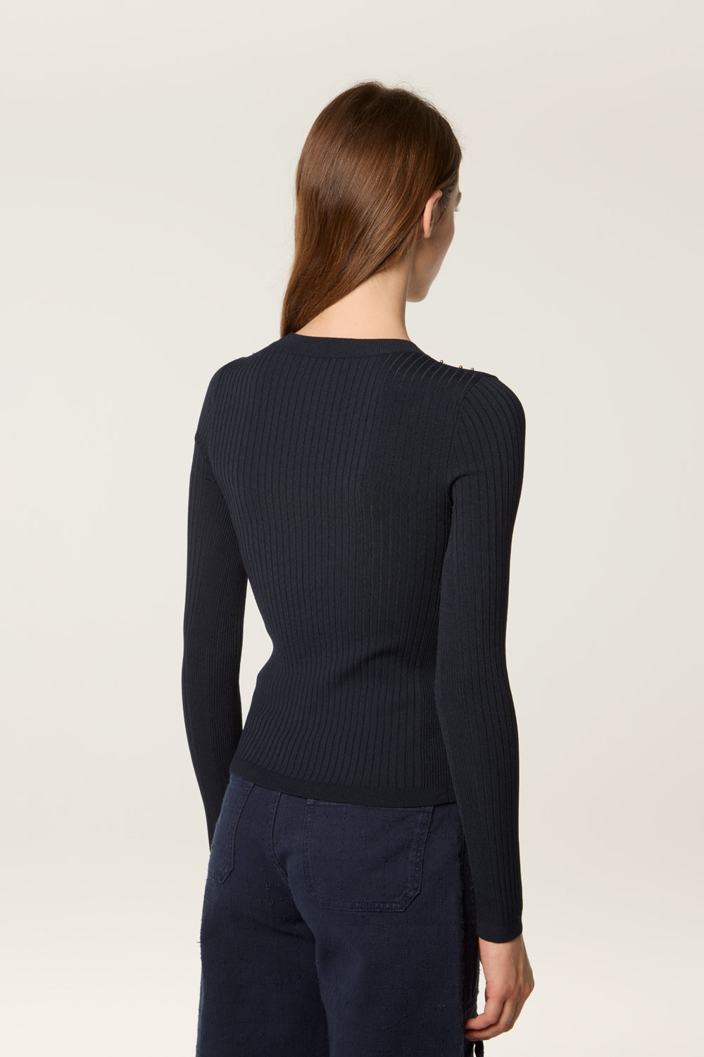 Sweater decorated with golden beads