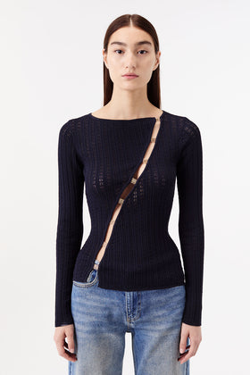 Knit top with cutouts and gold jewelry
