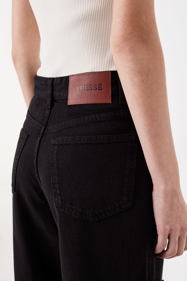 Denim noir ouvert aux côtés avec pattes tressées
