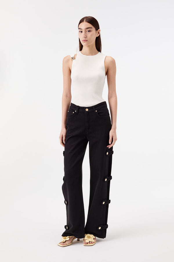 Denim noir ouvert aux côtés avec pattes tressées