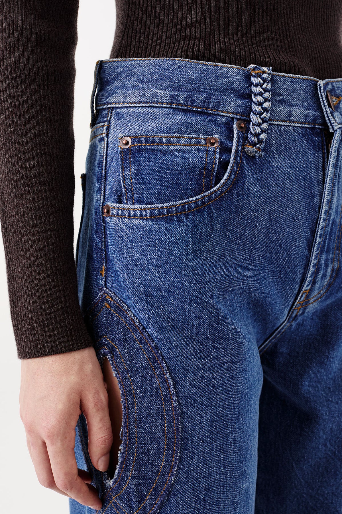 Denim jeans with braided opening