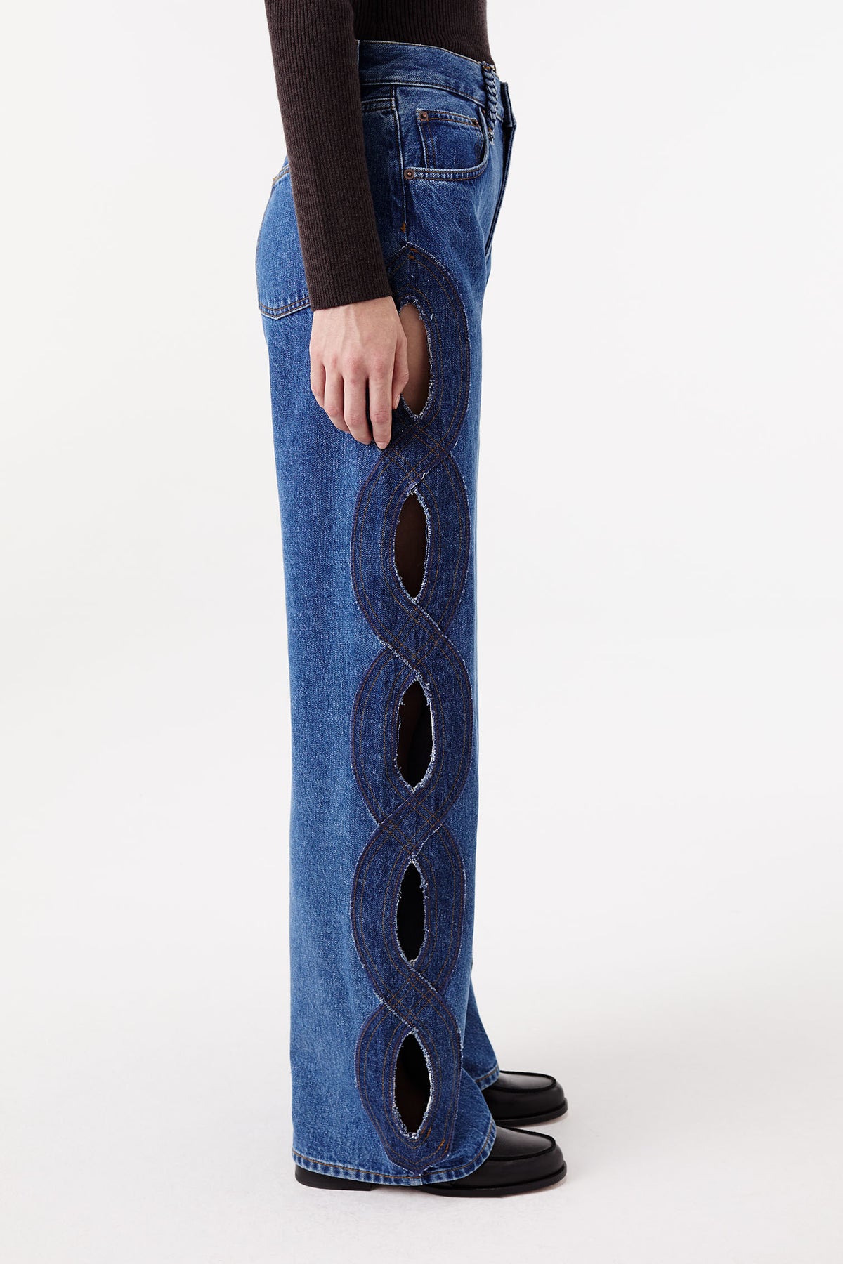 Denim jeans with braided opening