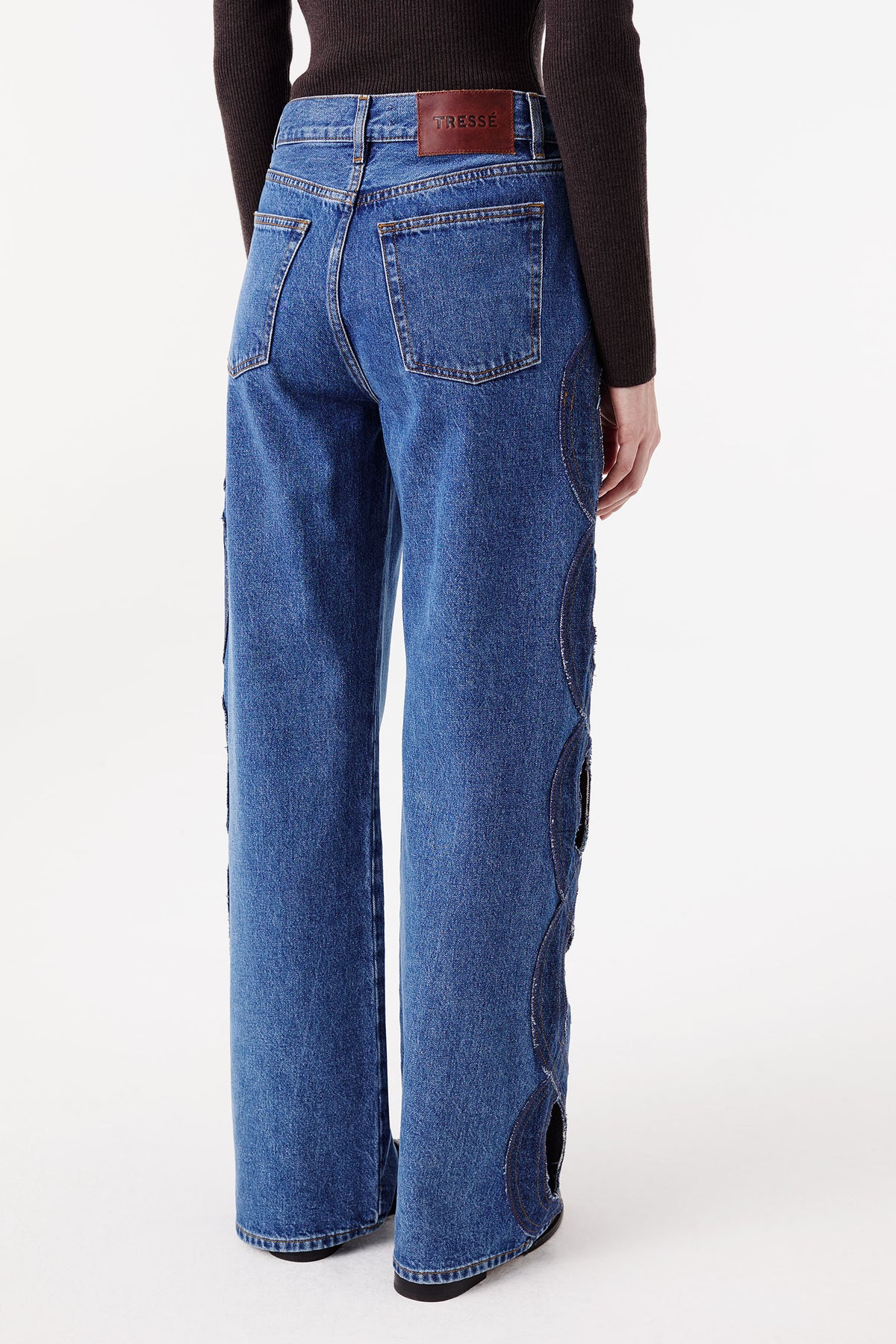 Denim jeans with braided opening