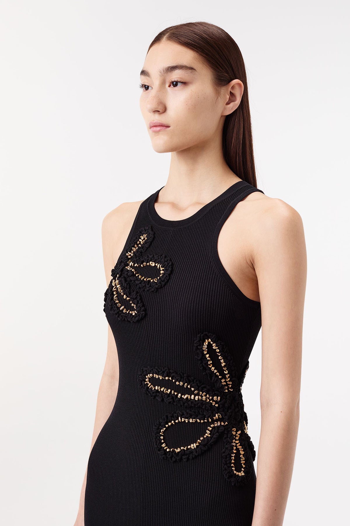 Dress with flowers embellished with gold jewelry